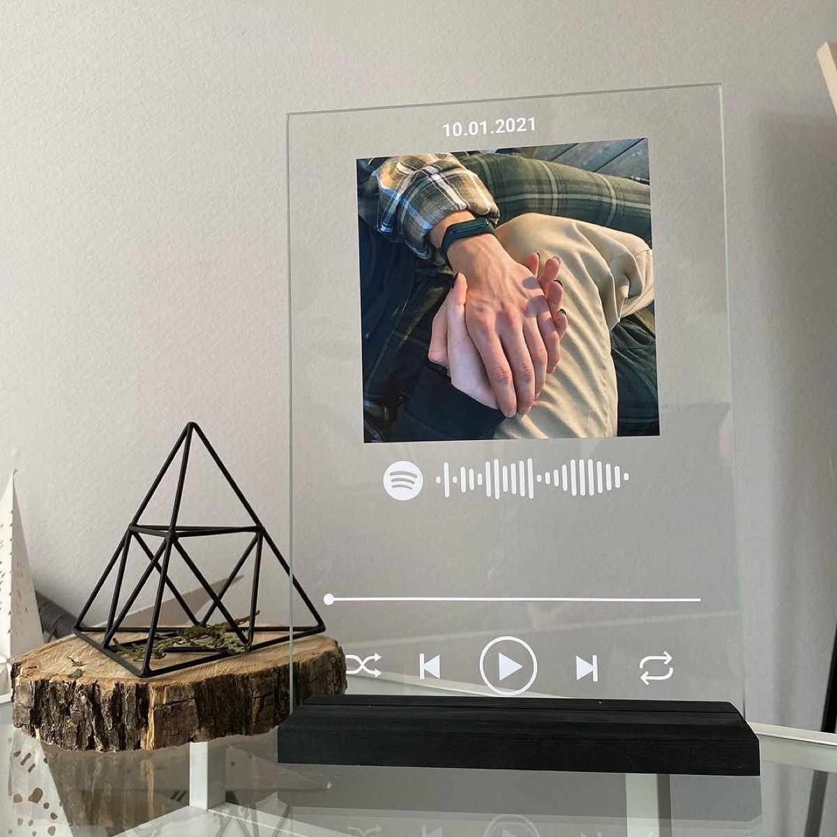 Living Frame styled on a shelf with soft lighting